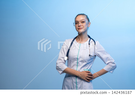 Young female doctor wearing stethoscope and glasses Young female doctor wearing stethoscope and glasses 142436187