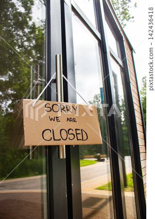 Sign SORRY WE ARE CLOSED on welcome door of small shop. Local business closure. Owners facing economic struggles and client loss Sign SORRY WE ARE CLOSED on welcome door of small shop. Local business closure. Owners facing economic struggles and client loss 142436418