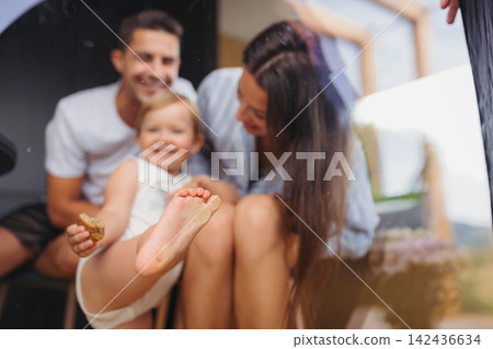 Young woman with husband and baby indoors, weekend away in small cotage n countryside. Young woman with husband and baby indoors, weekend away in small cotage n countryside. 142436634