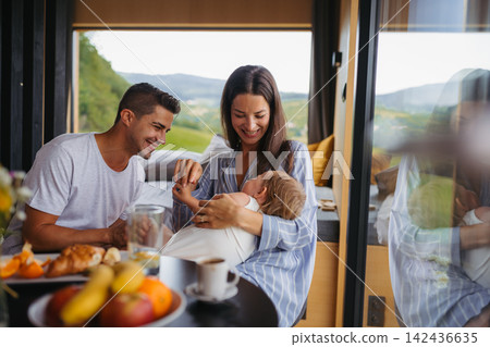 Family spending summer weekend away in cottage house in countryside. Family spending summer weekend away in cottage house in countryside. 142436635