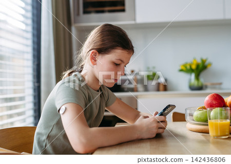 Teen girl with diabetes scanning glucose level using CGM sensor and smartphone. Teen girl with diabetes scanning glucose level using CGM sensor and smartphone. 142436806