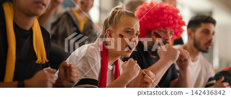 Worried football fans supproting German national team in live soccer match at stadium. Worried football fans supproting German national team in live soccer match at stadium. 142436842