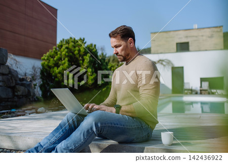 Man making online order or working from home on terrace. 142436922