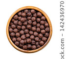 Choco balls, crispy breakfast cereal in wooden bowl, isolated from above. Crispy corn food made of toasted cornmeal, cocoa powder, sweetened with sugar, enjoyed with milk, or eaten as a snack. Photo Choco balls, crispy breakfast cereal in wooden bowl, isolated from above. Crispy corn food made of toasted cornmeal, cocoa powder, sweetened with sugar, enjoyed with milk, or eaten as a snack. Photo 142436970