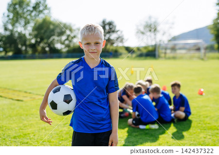 Mixed youth football team standing together on soccer field before training. Mixed youth football team standing together on soccer field before training. 142437322