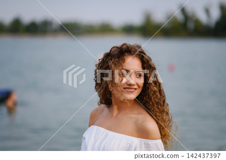 Beautiful woman at summer festival, standing in lake. Beautiful woman at summer festival, standing in lake. 142437397
