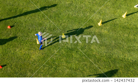 Areal view of football player running agility drills during soccer practice. Areal view of football player running agility drills during soccer practice. 142437432