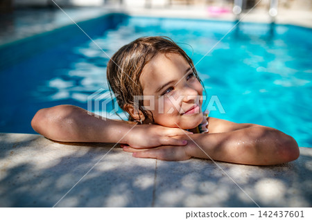 Happy girl resting in swimming pool with soft smile. Happy girl resting in swimming pool with soft smile. 142437601