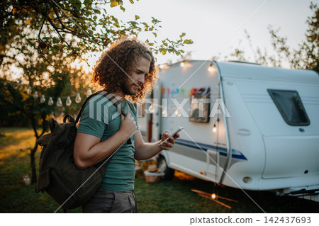 Young man is on a camping trip in nature alone. Caravan traveling for young people. 142437693