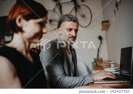 Man and woman having business meeting in a coffee shop. 142437767