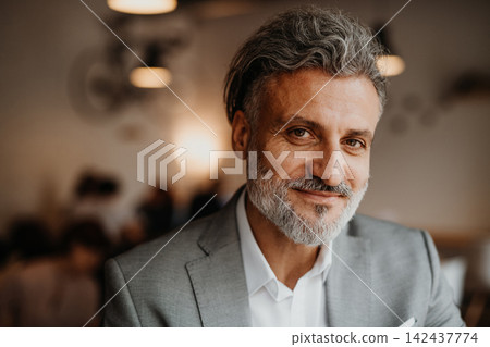 Focused senior manager working in modern office. Focused senior manager working in modern office. 142437774