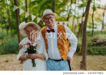 Senior couple having marriage in nature during autumn day. Senior couple having marriage in nature during autumn day. 142437962