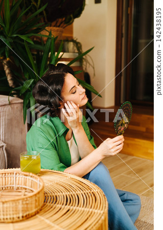Portrait of woman with hair rollers during slow morning. Portrait of woman with hair rollers during slow morning. 142438195