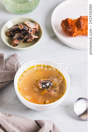 Delicious canned sardine soup in a bowl on the table vertical view Delicious canned sardine soup in a bowl on the table vertical view 142438360