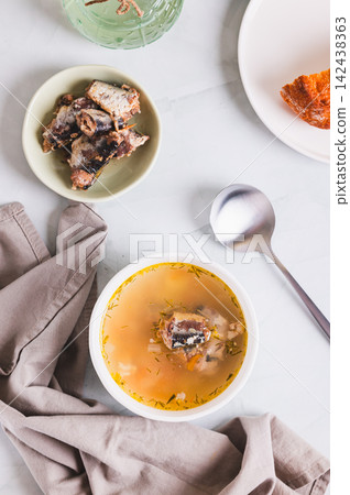 Delicious canned sardine soup in a bowl on the table top and vertical view Delicious canned sardine soup in a bowl on the table top and vertical view 142438363