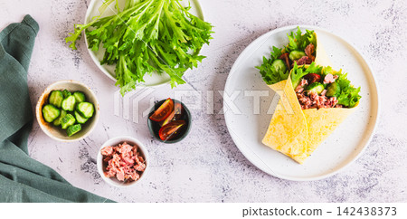 Vegetarian roll with tuna, vegetables and herbs on a plate on the table top view web banner Vegetarian roll with tuna, vegetables and herbs on a plate on the table top view web banner 142438373