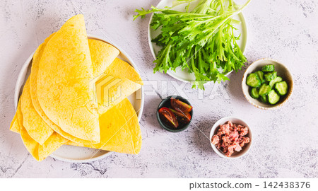 Ingredients for making rolls with tuna, vegetables and herbs on a plate on the table top view web banner Ingredients for making rolls with tuna, vegetables and herbs on a plate on the table top view web banner 142438376