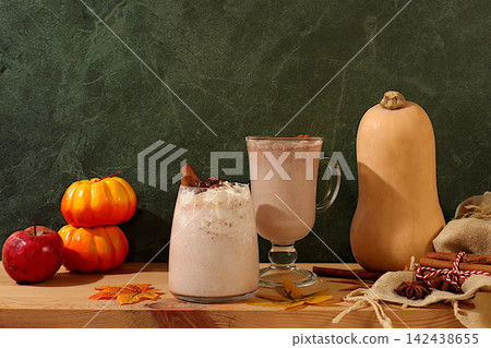 Seasonal abstract composition with hot autumn drink, warming pumpkin latte with cinnamon, star anise, pumpkin and fallen leaves, banner for screen, autumn greeting concept, cafe or restaurant menu Seasonal abstract composition with hot autumn drink, warming pumpkin latte with cinnamon, star anise, pumpkin and fallen leaves, banner for screen, autumn greeting concept, cafe or restaurant menu 142438655
