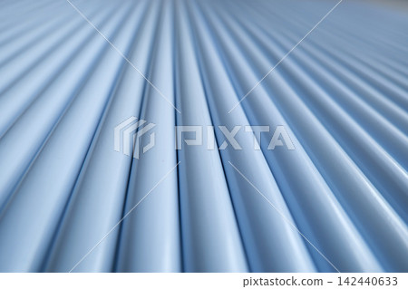 Steel pipes stacked in industrial warehouse close up Steel pipes stacked in industrial warehouse close up 142440633