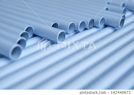 Rows of light gray PVC pipes arranged in a wave pattern Rows of light gray PVC pipes arranged in a wave pattern 142440671