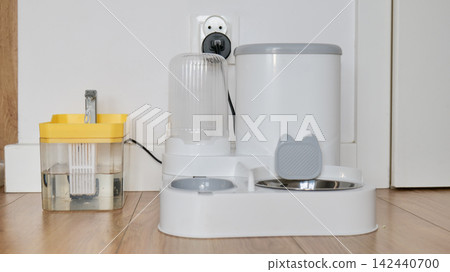 Automatic Pet Feeder and Water Dispenser for Cats and Dogs on a Wooden Floor 142440700