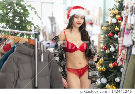 Young girl in underwear tries on plaid coat, New Years Eve Young girl in underwear tries on plaid coat, New Years Eve 142441246