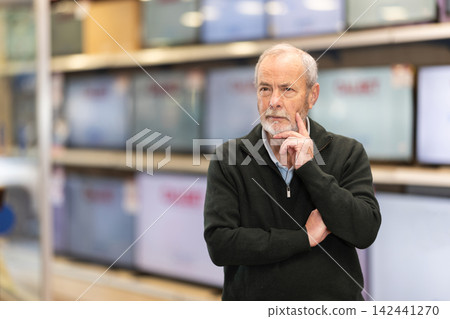 Elderly man chooses TV in appliance store Elderly man chooses TV in appliance store 142441270