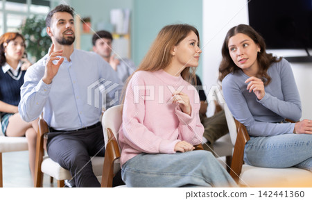 Classmates listening and talking during group discussion in class Classmates listening and talking during group discussion in class 142441360