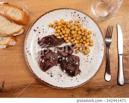Stewed or fried beef tenderloin is served with chickpea ragout Stewed or fried beef tenderloin is served with chickpea ragout 142441471