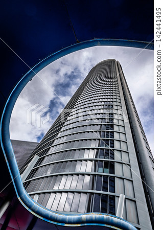 Modern skyscraper framed by curved canopy, Madrid, Spain Modern skyscraper framed by curved canopy, Madrid, Spain 142441495