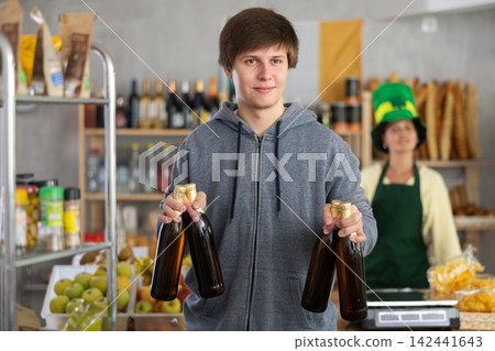 Young man choosing beer in grocery store 142441643