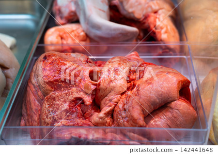 Raw lungs in tray displayed in store meat counter Raw lungs in tray displayed in store meat counter 142441648