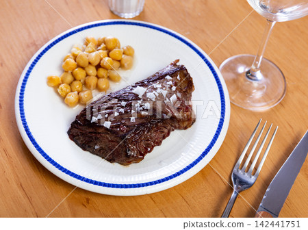 Cooked beef meat with chickpeas on a plate top view 142441751