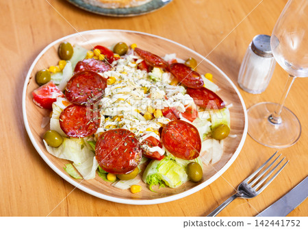Delicious salad with following ingredients: pork sausage, avocado, corn, salt, olives, tomato, onion Delicious salad with following ingredients: pork sausage, avocado, corn, salt, olives, tomato, onion 142441752