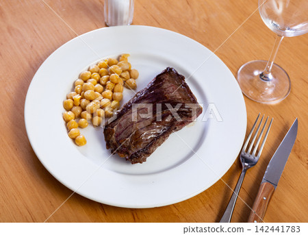 Veal steak with chickpeas on plate Veal steak with chickpeas on plate 142441783