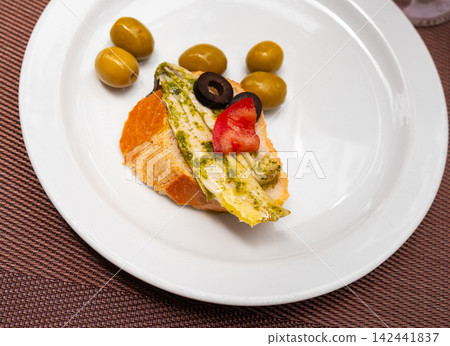 Sandwiches with anchovy are laid out on large plate. Sandwiches with anchovy are laid out on large plate. 142441837