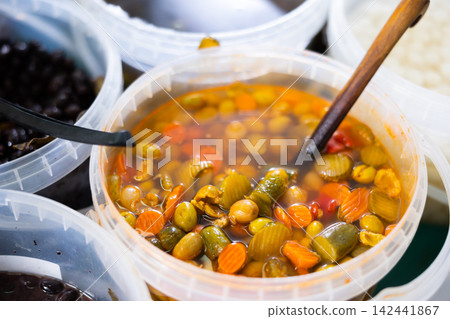 Green olives carrots and cucumbers pickled in barrels Green olives carrots and cucumbers pickled in barrels 142441867