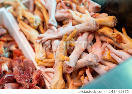 Tray is filled with chicken paws, chilled meat products. Tray is filled with chicken paws, chilled meat products. 142441875