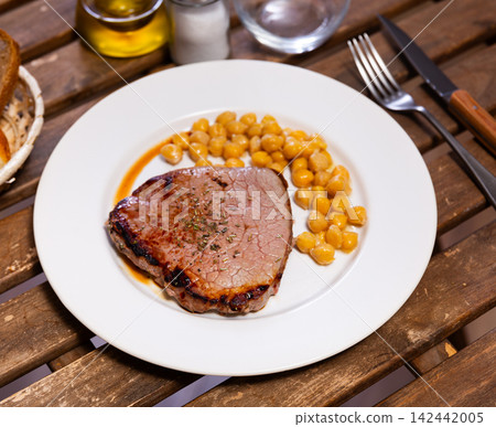 Stewed or fried beef tenderloin is served with chickpea ragout Stewed or fried beef tenderloin is served with chickpea ragout 142442005