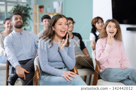 Group of happy students laughing during educational class Group of happy students laughing during educational class 142442012
