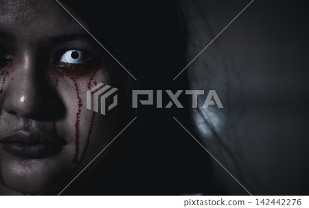Close up of horror bloodthirsty ghost female with fade drop out from eyes Close up of horror bloodthirsty ghost female with fade drop out from eyes 142442276