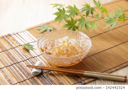 圖片顯示的是用筷子夾起瓊脂果凍(tokoroten)。 圖片顯示的是用筷子夾起瓊脂果凍(tokoroten)。 142442324