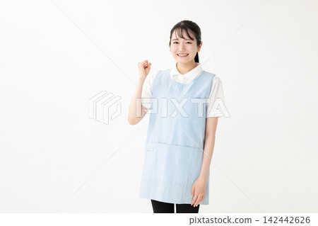 A woman in an apron with a guts pose A woman in an apron with a guts pose 142442626