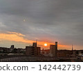 Watching the sunset being chased by rain clouds from a pedestrian overpass. 142442739