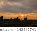 Watching the sunset being chased by rain clouds from a pedestrian overpass. 142442741