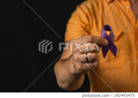 Support for health awareness through a ribbon held by a man Support for health awareness through a ribbon held by a man 142443475