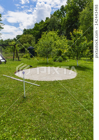 Preparing the ground for an above ground swimming pool in the backyard 142443498