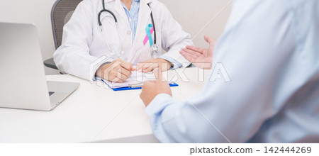 Doctor and patient having a medical consultation for blue and pink ribbon concept of October male Breast Cancer Awareness month, National Cancer Survivors Month and Pink October Healthcare 142444269