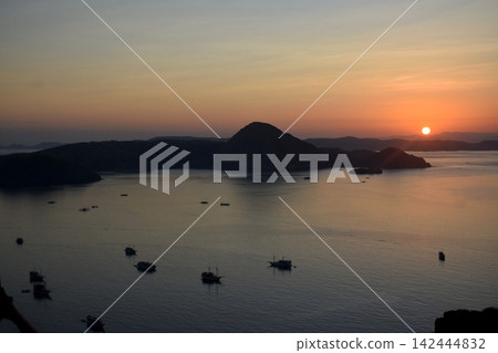The beautiful sunrise on Padar Island in West Manggarai, Flores, Indonesia, with its reddish-yellow rays. 142444832