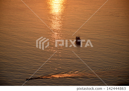 The beautiful sunrise on Padar Island in West Manggarai, Flores, Indonesia, with its reddish-yellow rays. 142444863
